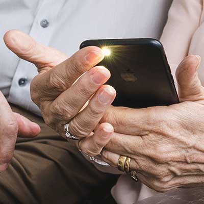 A fingertip resting on a phone camera during a measurement